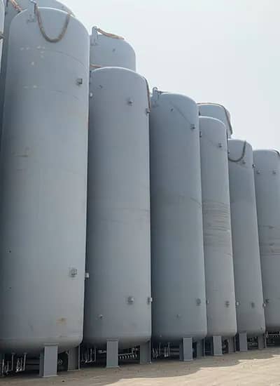 Large industrial cryogenic tanks used for storing liquefied gases such as nitrogen, oxygen, or LNG.