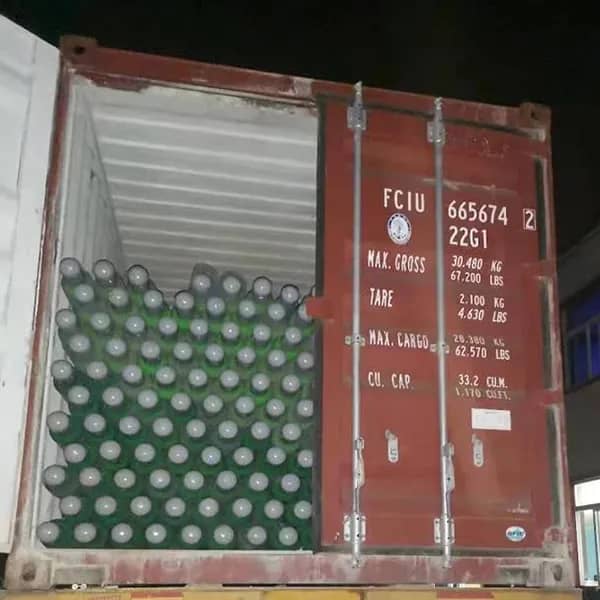 High-pressure gas bottles being loaded for transport.