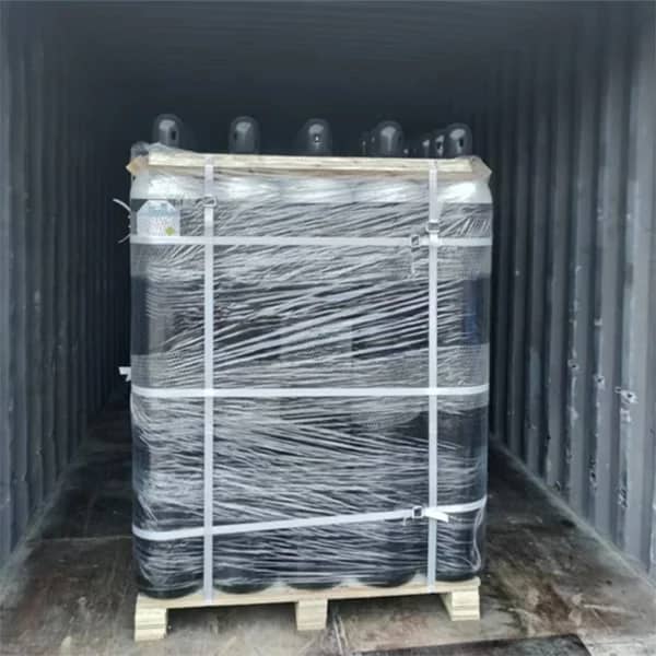 Oxygen cylinders neatly arranged and secured on pallets inside a shipping container