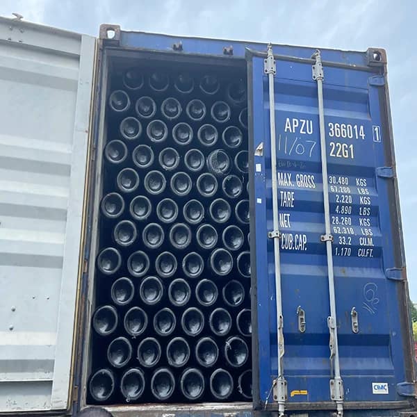 Driver unloading a pressure gas bottle from a lift‑gate truck for doorstep delivery”