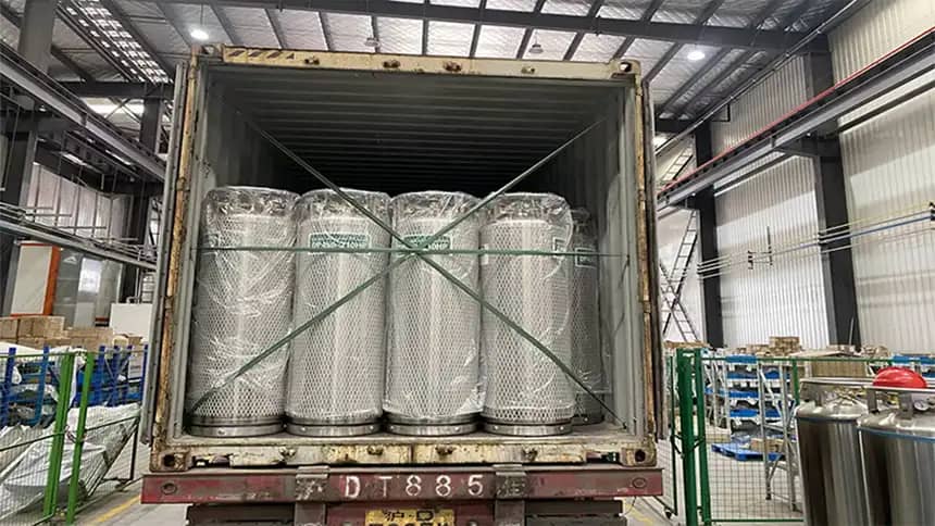 Liquid nitrogen dewar being securely loaded onto a transport vehicle for delivery